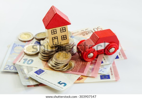 wooden toy house,\
car, coins and banknotes\
