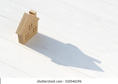 Wooden Toy House On Table, On White Background