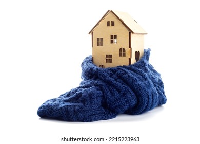 Wooden Toy House Is Wrapped In A Warm Scarf Isolated On White Background