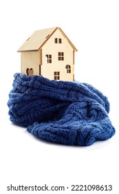 Wooden Toy House Is Wrapped In A Warm Scarf Isolated On White Background