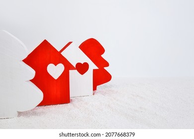 Wooden Toy Houses And Christmas Trees On A Light Background. Home Love And Happiness Concept, Business Concept Of Financial Loan, Real Estate Insurance
