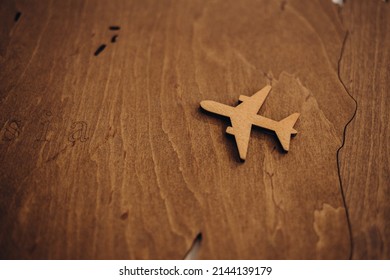 Wooden Toy Plane Hand Carved Model On Hardwood Floor.