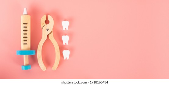 Wooden Toy Set Flat Laying On The Pink Background In The Concept Of Dental Caries, Remove Tooth, Gum Disease, Toothache  And Having Good Health.