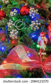 A Wooden Toy Soldier Hangs On A Patriotic Christmas Tree In Red, White , And Blue.