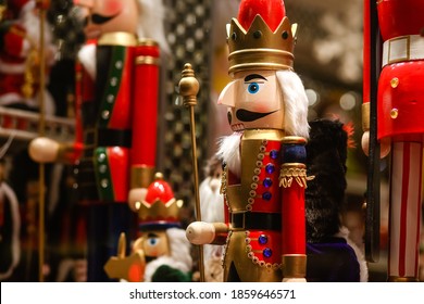 Wooden Toy Soldier Nutcracker In A Red Suit On The Shop Window.Buying Gifts And Souvenirs For The Holiday.Happy New Year!Merry Christmas!Christmas Shopping.