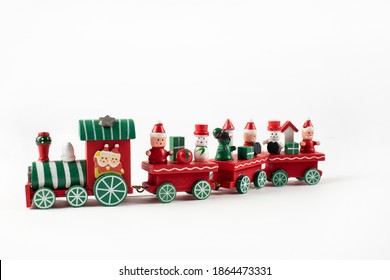 Wooden toy train. Christmas trip on a white isolated background. Christmas card. Copy space.