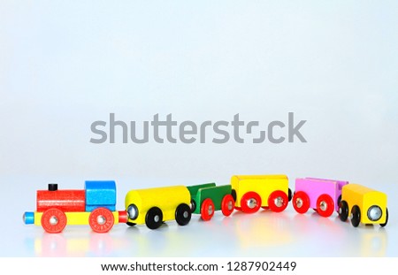wooden toy train set on a white shiny surface no people stock photo