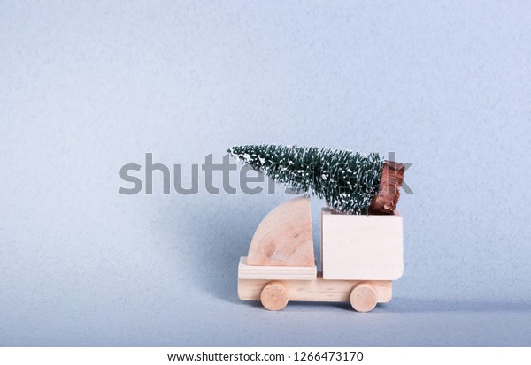 Wooden toy truck\
with christmas tree on is\
top