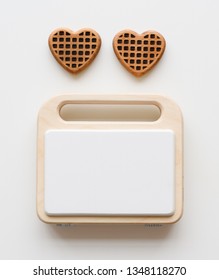 Wooden Toy Waffle Maker And Two Chocolate Color Wooden Waffles. Waldorf Toys On White Background