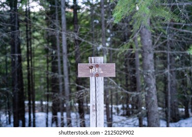 A Wooden Trail Sign On A Hiking Trail