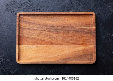 Wooden tray, cutting board. Dark background. Copy space. Top view.