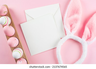 Wooden Tray With Easter Eggs, Fluffy Bunny Ears And White Empty Card For Congratulations. Mockup. Easter Holiday Concept. Top View, Copy Space. Flat Lay