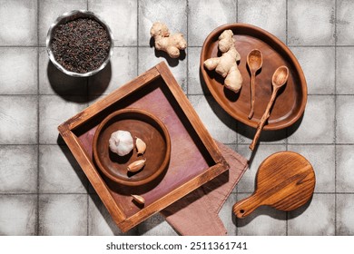 Wooden tray with ginger, garlic, rice and cutting board on grey tile background - Powered by Shutterstock