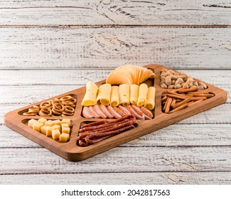 Wooden Tray With Meat And Cheese, Antipasto Snacks. Antipasto Cold Meat Dish With Breadsticks, Prosciutto, Ham, Ham Slices And Cheese On A Wooden Tray