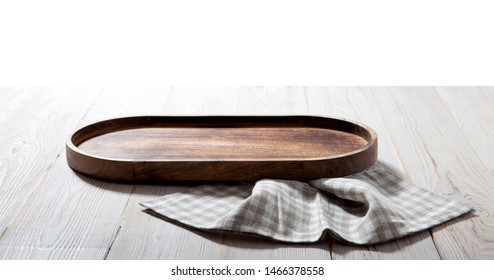 Wooden tray and napkin on white wooden table. Empty tray. Mockup for design. Top view.