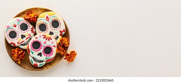 Wooden tray with tasty cookies in shape of skull for Mexico's Day of the Dead (El Dia de Muertos) on light background with space for text - Shutterstock ID 2213023665