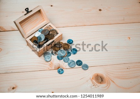 Wooden Treasure Chest on a wooden background with a silver and gold coins. Pirate Games concept Money Laundry, Vintage Tone