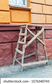 Wooden Trestle Table Next To A Freshly Painted Wall