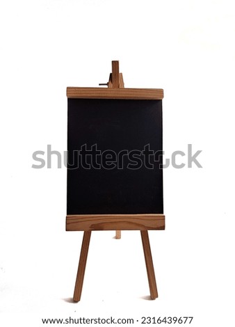Wooden trivet chalkboard It is a blank blackboard to put the letters on. The black blackboard floor is placed on a white crate.