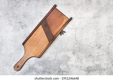 Wooden vintage mandoline on a marble table in a top view