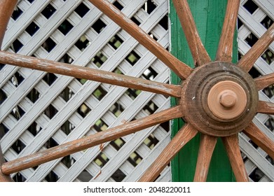 wooden wagon wheel against fence