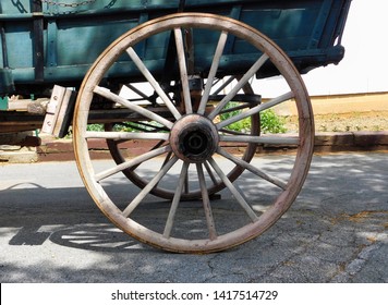 A wooden wagon wheel of an old fashioned Conestoga wagon; at the Amish Farm and House in Lancaster, Pennsylvania