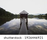 Wooden walkway leading to old boat house on lake Muehlteich Muhlteich Woerthersee Moosburg Carinthia Austria in Europe