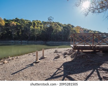 Wooden walkway next to lake with little water. Climate change drought concept - Powered by Shutterstock