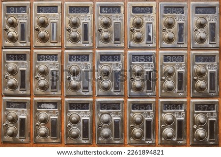 Wooden wall with ancient American safe deposit mail boxes
