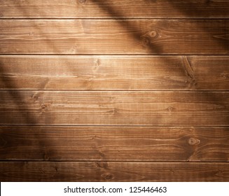 Wooden wall background in a morning light. With shadows from a window frame. - Shutterstock ID 125446463