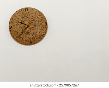 A wooden wall clock adorned with an array of abstract shapes, adding a touch of artistic flair to any room.