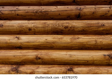 Wooden wall from logs of pine as a background texture.  - Shutterstock ID 653781970