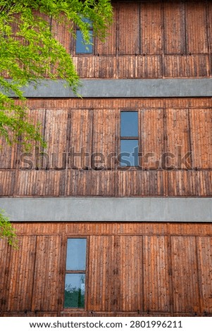 Wooden wall surfaces complementing the greenery of the building.