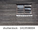 Wooden wall and two classic windows of the old house