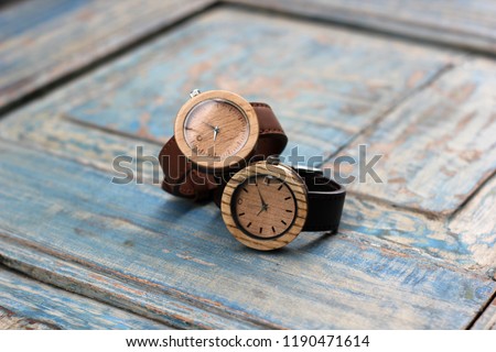 wooden watch with leather wrist, photo product, with natural wood background