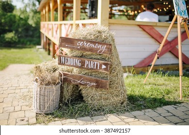 Wooden Wedding Sign With Indication Of Direction Near Small A Stack Of Hay Outdoor