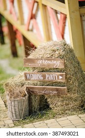 Wooden Wedding Sign With Indication Of Direction Near Small A Stack Of Hay Outdoor