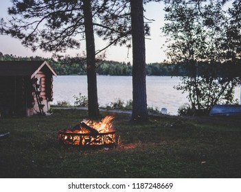 Wooden Weekend Cabin On A Lake In Summer With Bon Fire, Evening Picture