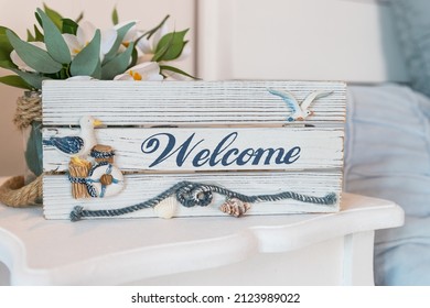 Wooden Welcome Sign On Reception In Hotel ,antique Rustic Board, Welcome Plate Made From Wood With Beautiful Maritime Decoration.Summer Time Sea Vacation Concept.