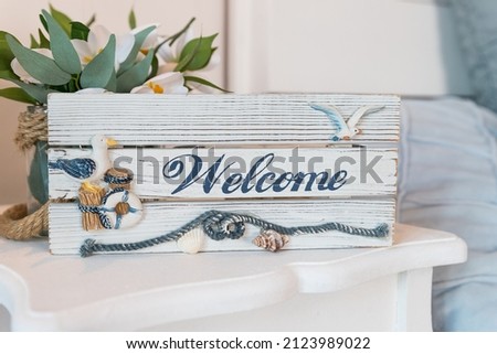 wooden Welcome sign on reception in hotel ,antique rustic board, Welcome Plate Made from Wood with Beautiful Maritime Decoration.Summer time sea vacation concept.