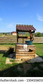 A Wooden Well With A Basin And A Towel. Against The Background Of Carpathian Nature.