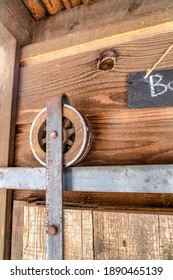 Wooden Wheel And Metal Track Of Bathroom Sliding Door With Chalkboard Signage