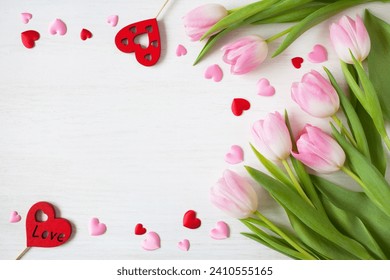 Wooden white background with pink tulips and hearts, copy space for text for the holiday Valentine's Day