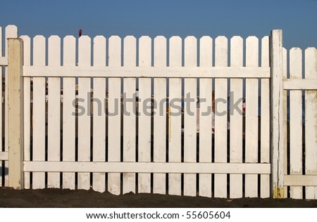 Wooden white fence on the beach