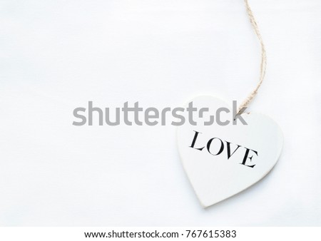 wooden white heart on white background with copy space 