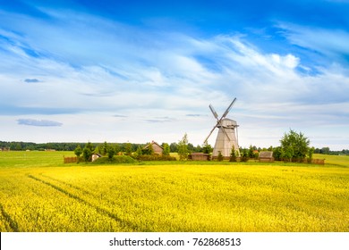 Wooden windmill on background field and sky. Dudutki village, Minsk Region, Belarus