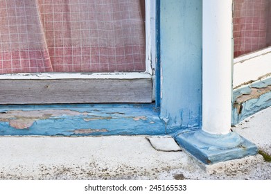 A Wooden Window Frame Showing Peeling Paint And Wood Rot