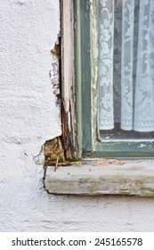 A Wooden Window Frame Showing Peeling Paint And Wood Rot