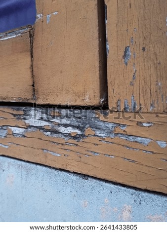 wooden window frames that look like they are starting to rot, crack and the paint is peeling