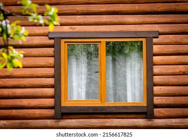 Wooden window on facade of house made of wooden beams. Pros and cons of wooden windows concept .